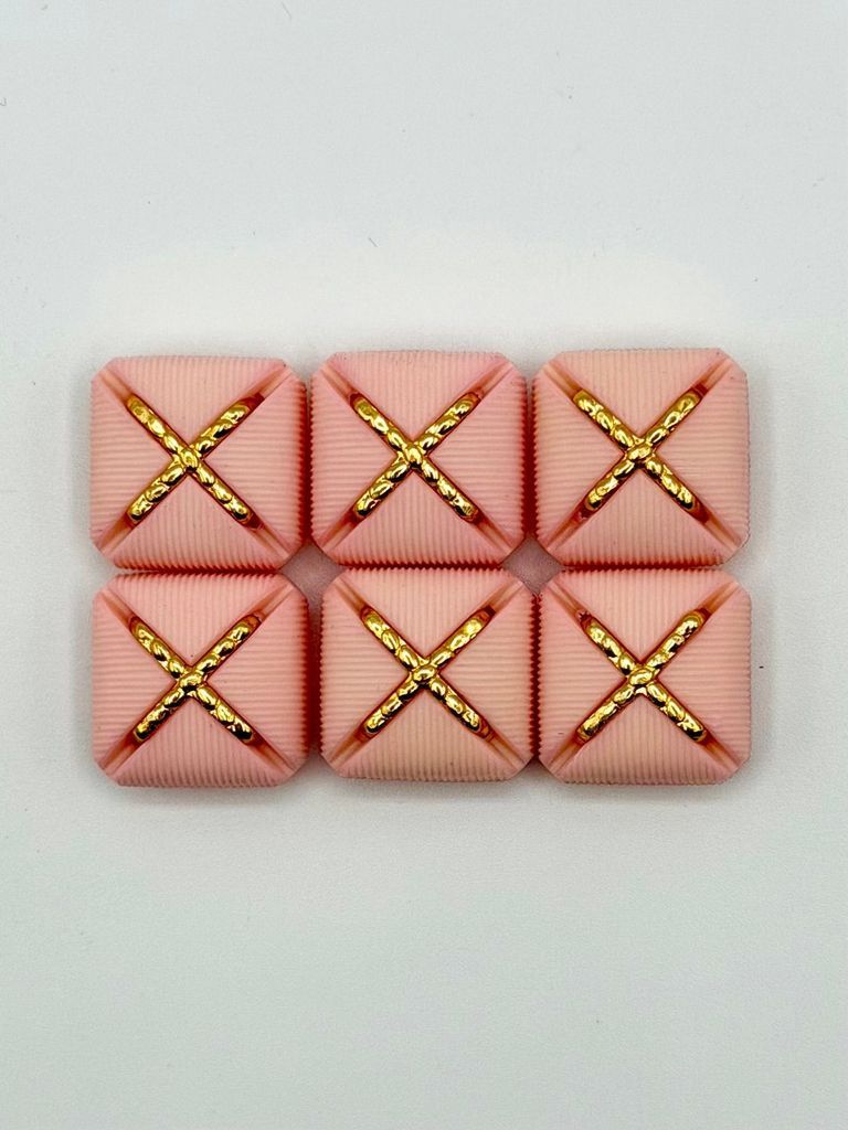 Set of six matching square buttons, pink with golden "X" motif