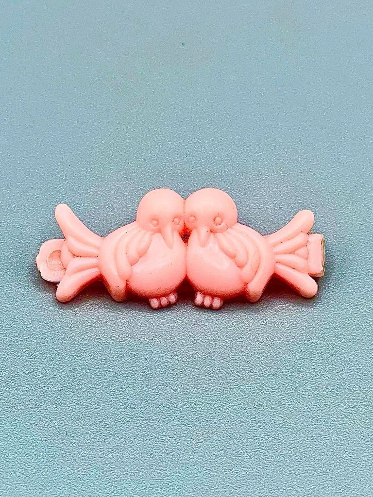 Molded-plastic toddler's hair barrette in the form of two birds