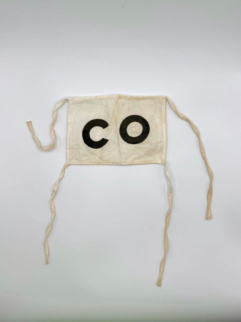 Cloth armband (brassard) lettered "CO" — Comité/Comisión Organizadora