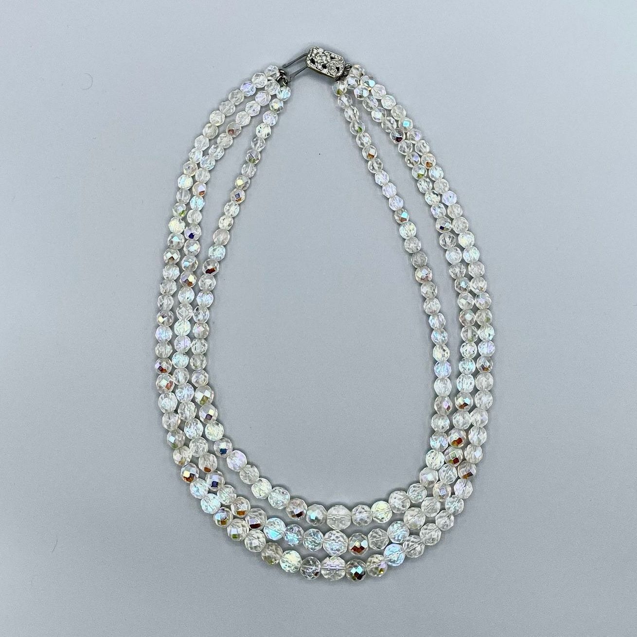          Triple-strand faceted glass bead necklace, clear 