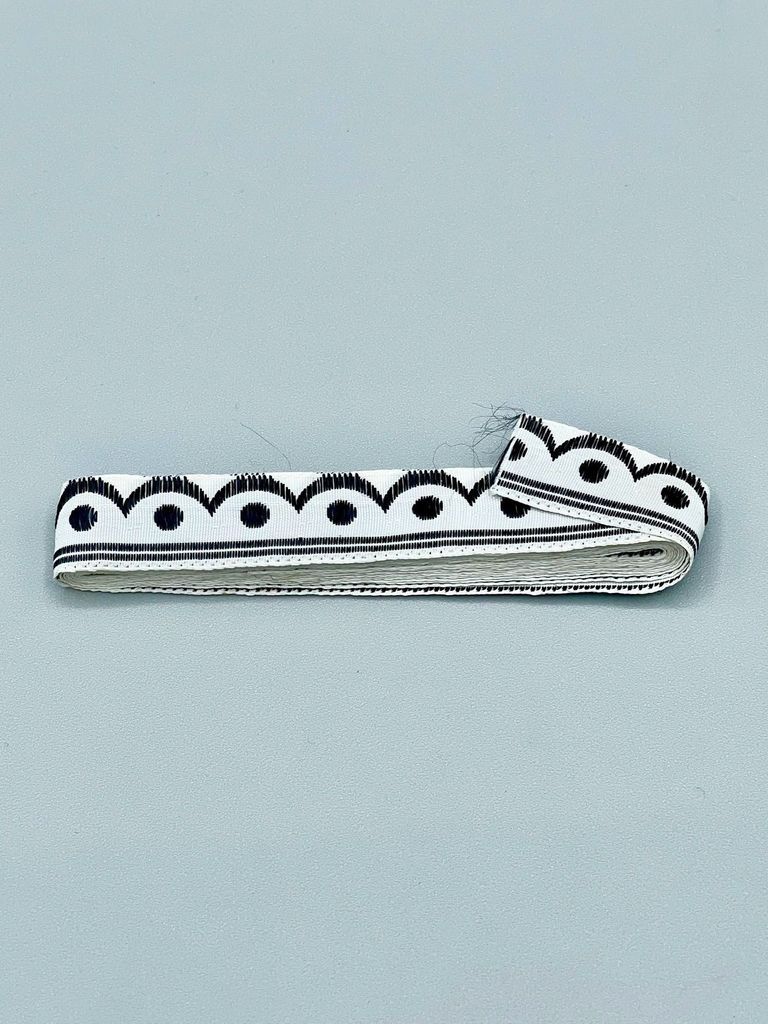 Woven ribbon trim, black-and-white scallop-and-dot pattern