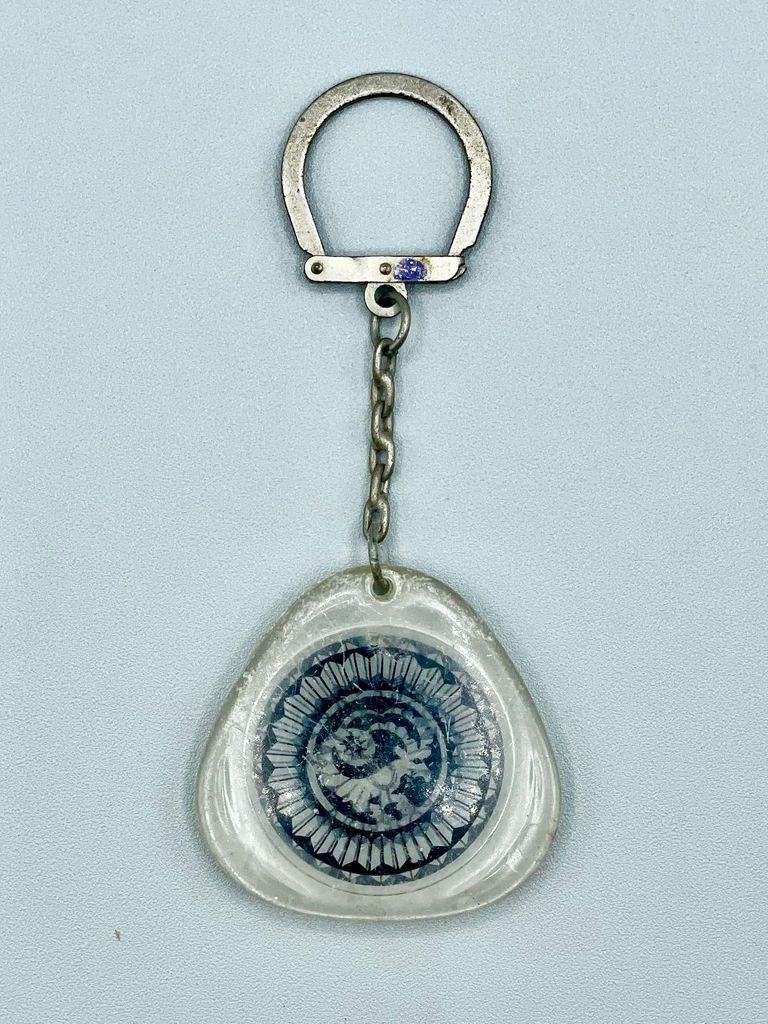 Keychain with clear plastic fob enclosing a goat emblem