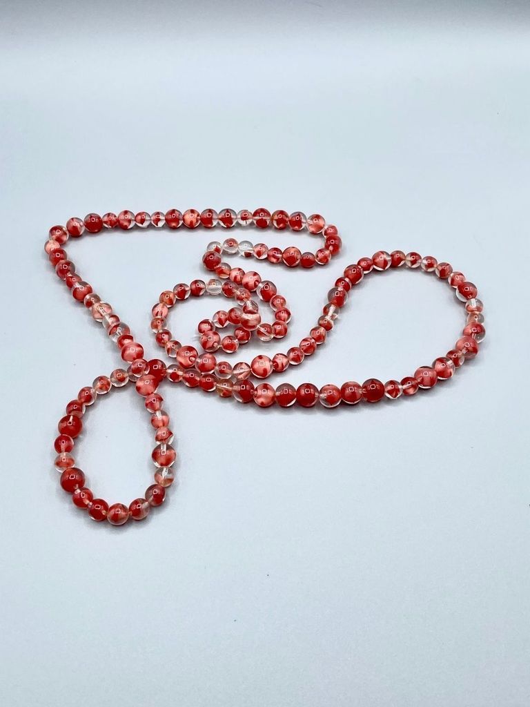 Long beaded necklace of red-and-clear glass beads (reassembled)