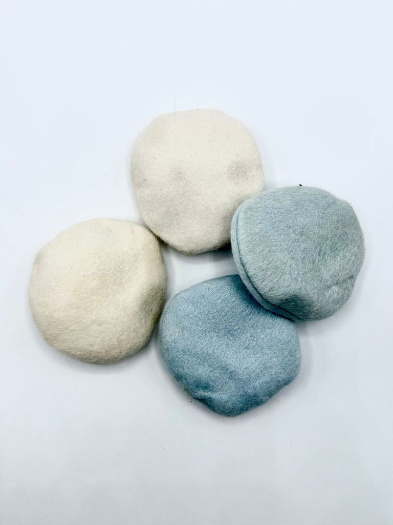 Set of four unused cosmetic powder puffs (off white and pale blue)