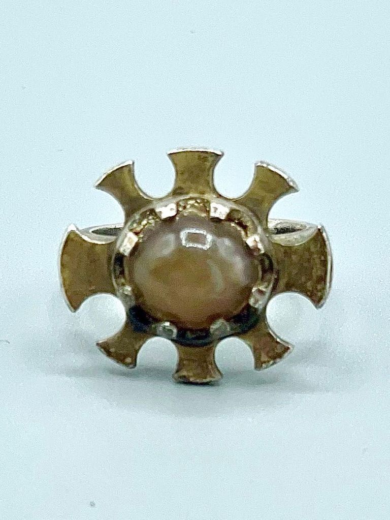 Ring with radiating sunburst setting and honey-colored cabochon
