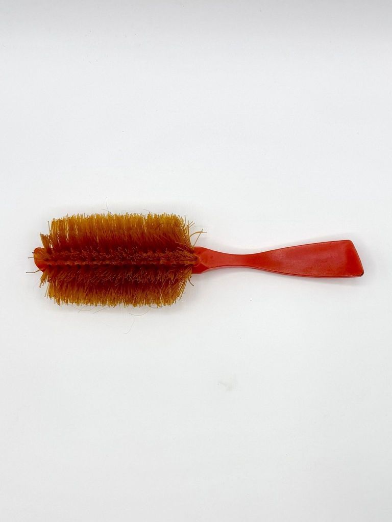 Plastic hairbrush with synthetic bristles, red