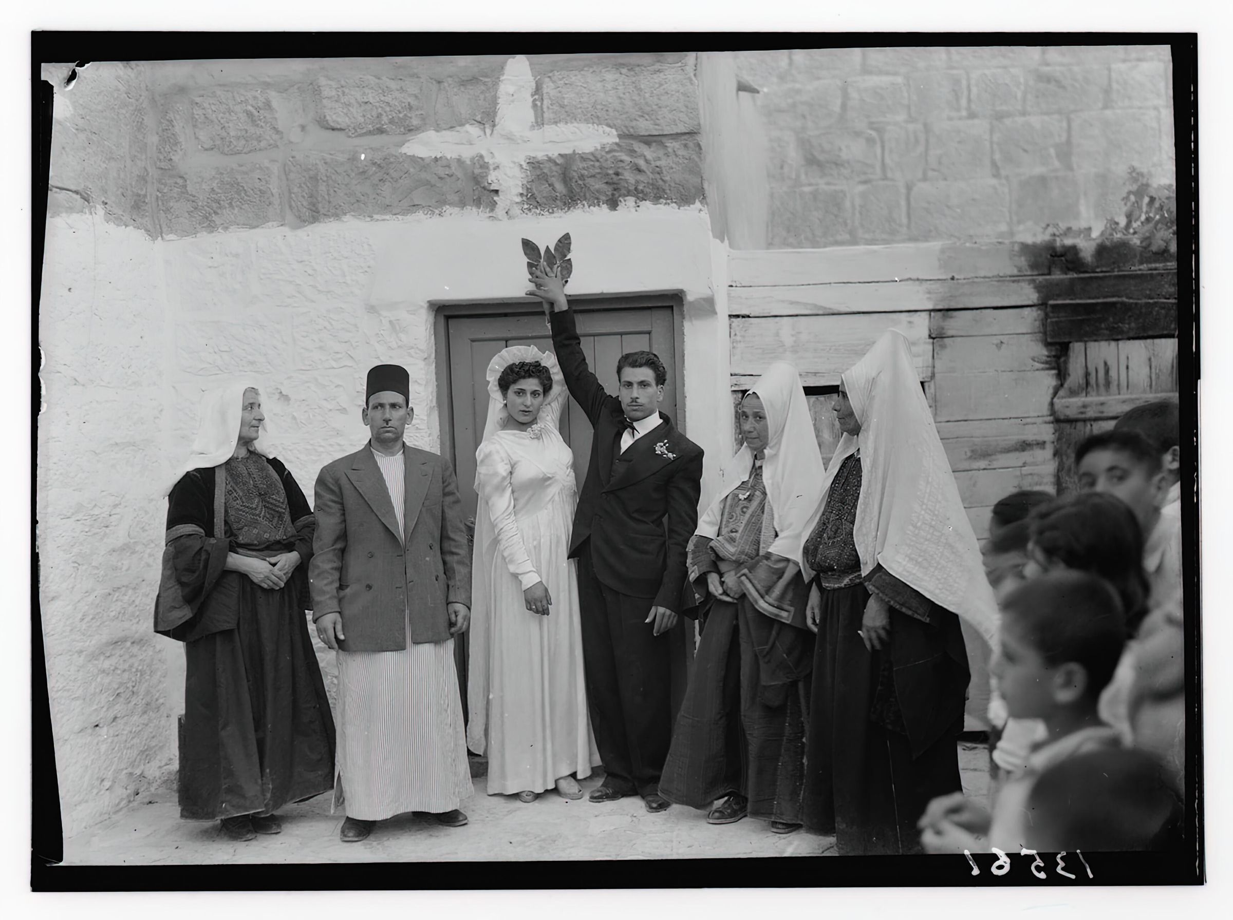 Bethlehem bride and groom touch leaf and yeast above the doorway to their prospective home. picture number 1