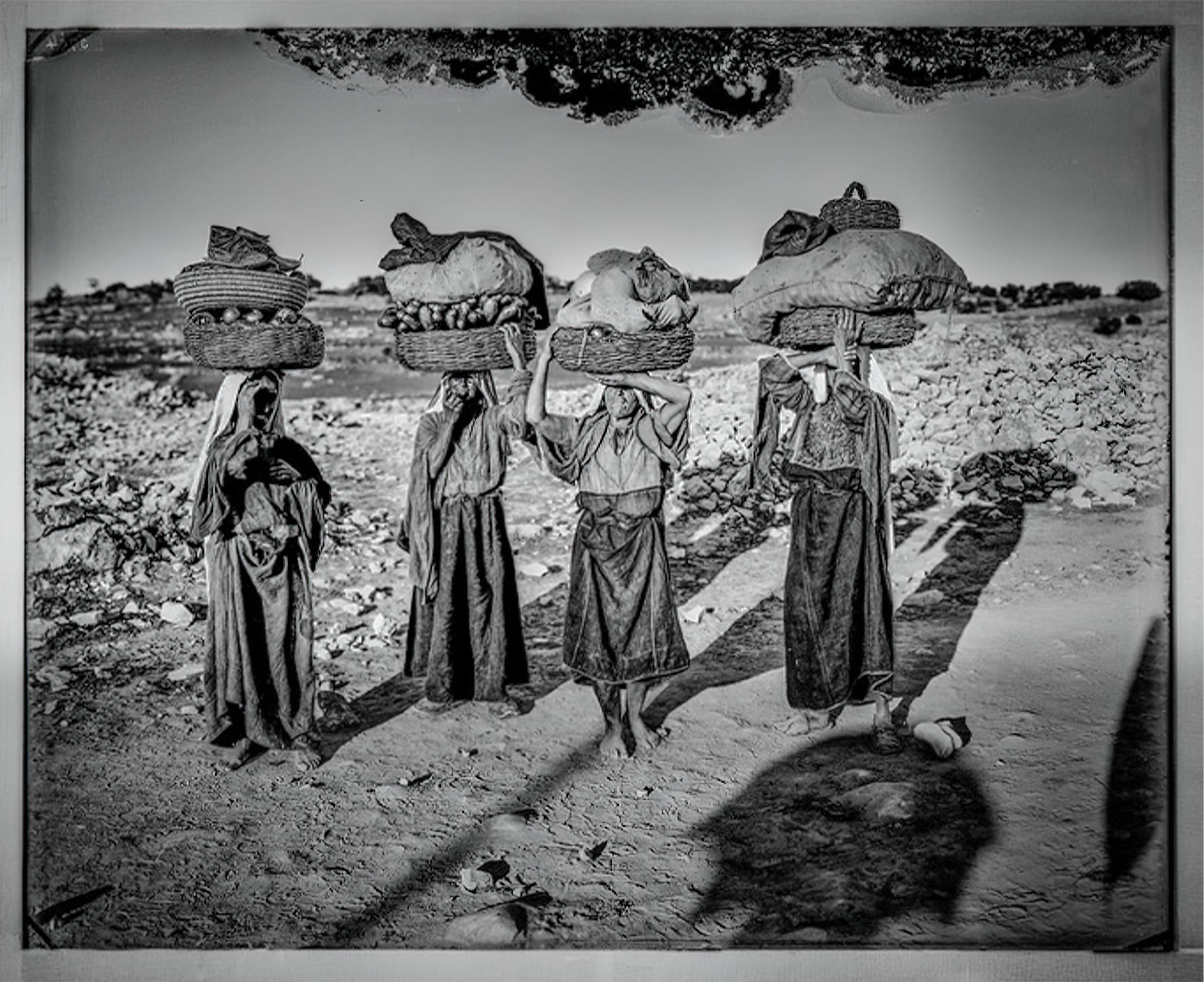 Four Palestinian women on their way to market with baskets on heads picture number 1