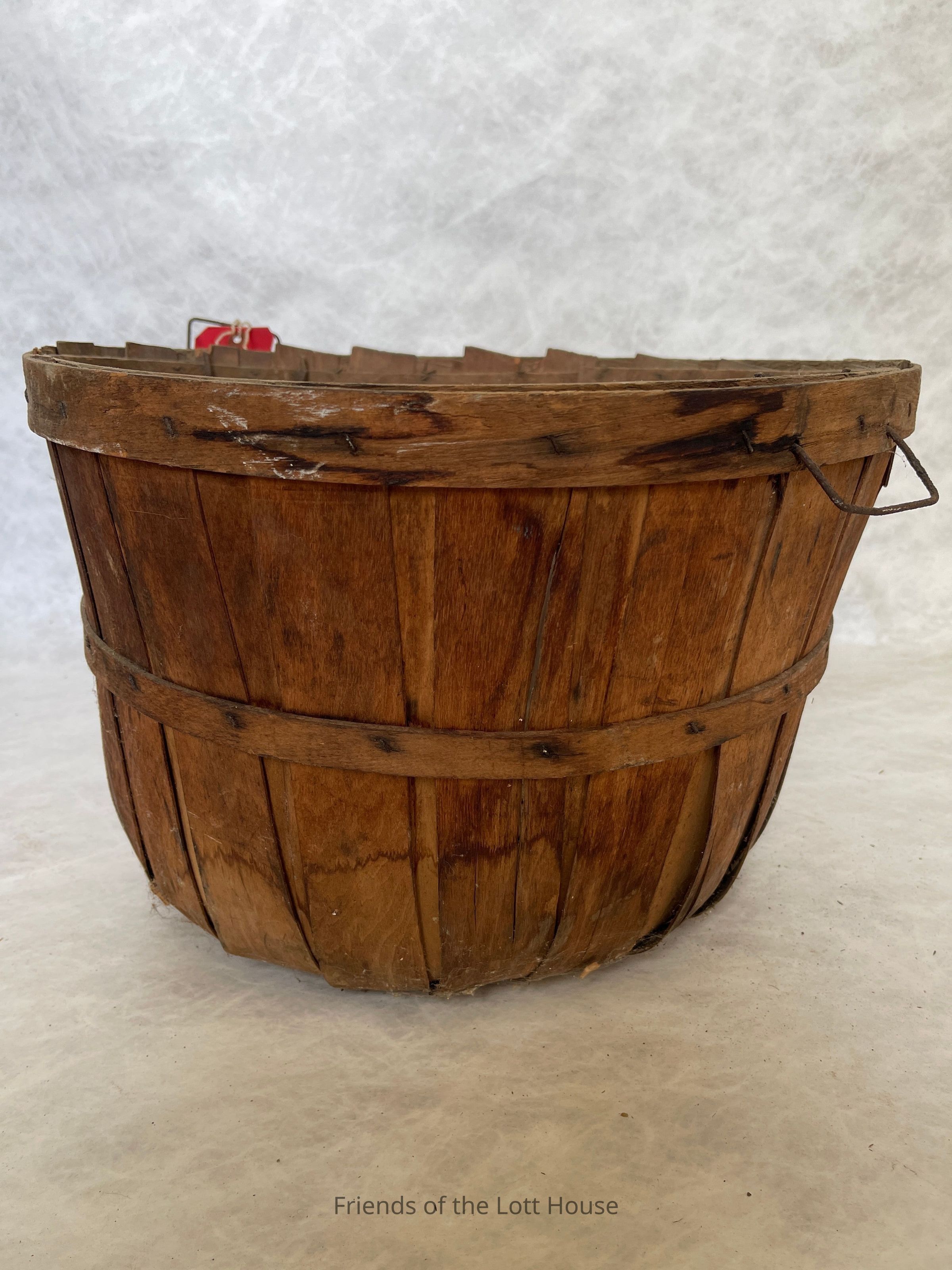 Like most residents of the Flatlands, the Lott family were farmers. Everyone in the household—regardless of gender or age—likely took part in farm duties ranging from cultivating the land to collecting eggs from the chickens. The Lott farm produced a variety of staple crops, including wheat, buckwheat, rye, oats, corn, flax, and barley. They also grew fruits and vegetables, such as potatoes, string beans, and cabbage, and raised dairy animals. Farm work was mostly manual in the 19th and early 20th centuries, and efficient tools were essential for gathering, carrying, and transporting crops. Baskets played a key role in this process, allowing workers to collect fruits, vegetables, and grains in a manageable way, which minimized the number of trips needed to transport goods. They helped workers gather large quantities of produce in a single load, improving overall efficiency. The Hendrick I. Lott House Collection includes several baskets used on the farm, offering a tangible connection to the daily labor that took place there.
These baskets, crafted from durable materials like wicker or wood, were essential tools for harvesting and transporting crops. Some of these baskets were made for picking berries, gathering beans, or collecting eggs. In addition to the baskets, the Lott House Collection reflects the diverse labor force that worked on the farm. Many of the farm workers were Irish immigrants, like many others during that period, who sought work on farms in the United States to make a living. Irish immigrants on the farm were part of a broader trend in the late 19th and early 20th centuries when many immigrants helped sustain agricultural production across the country.