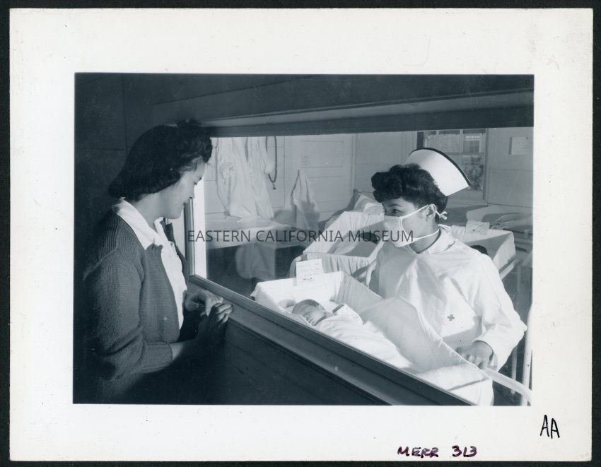 Nurse Aiko Hamaguchi, mother Frances Yokoyama, baby Fukomoto, Manzanar Relocation Center, California