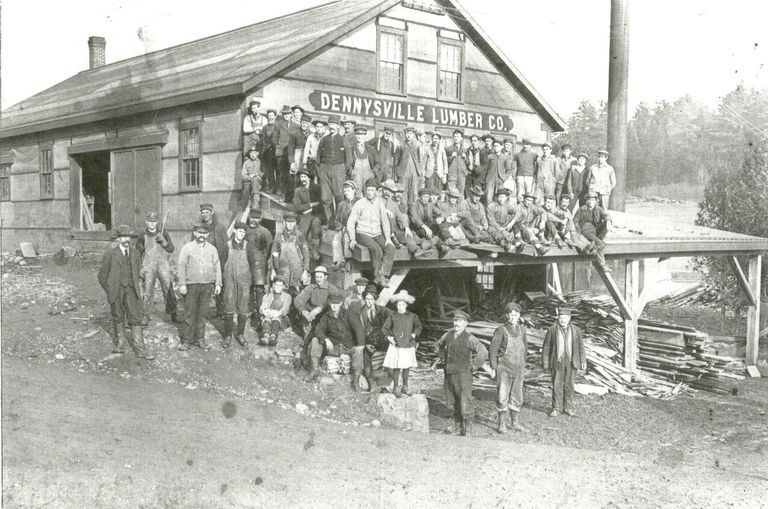         Dennysville Lumber Company, 1907; Dennysville Lumber Company workers pose for a picture beside their new mill building, with young Marie Mahar who happened along just in time.
   