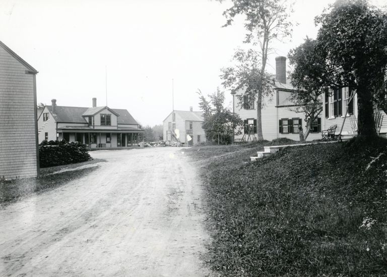          Store Hill After 1909, Dennysville, Maine; Store and G. A. R. Hall across the street, Howard Laughton's barber shop on left, and Benjamin Foster's and Will Allan's houses on right.
   