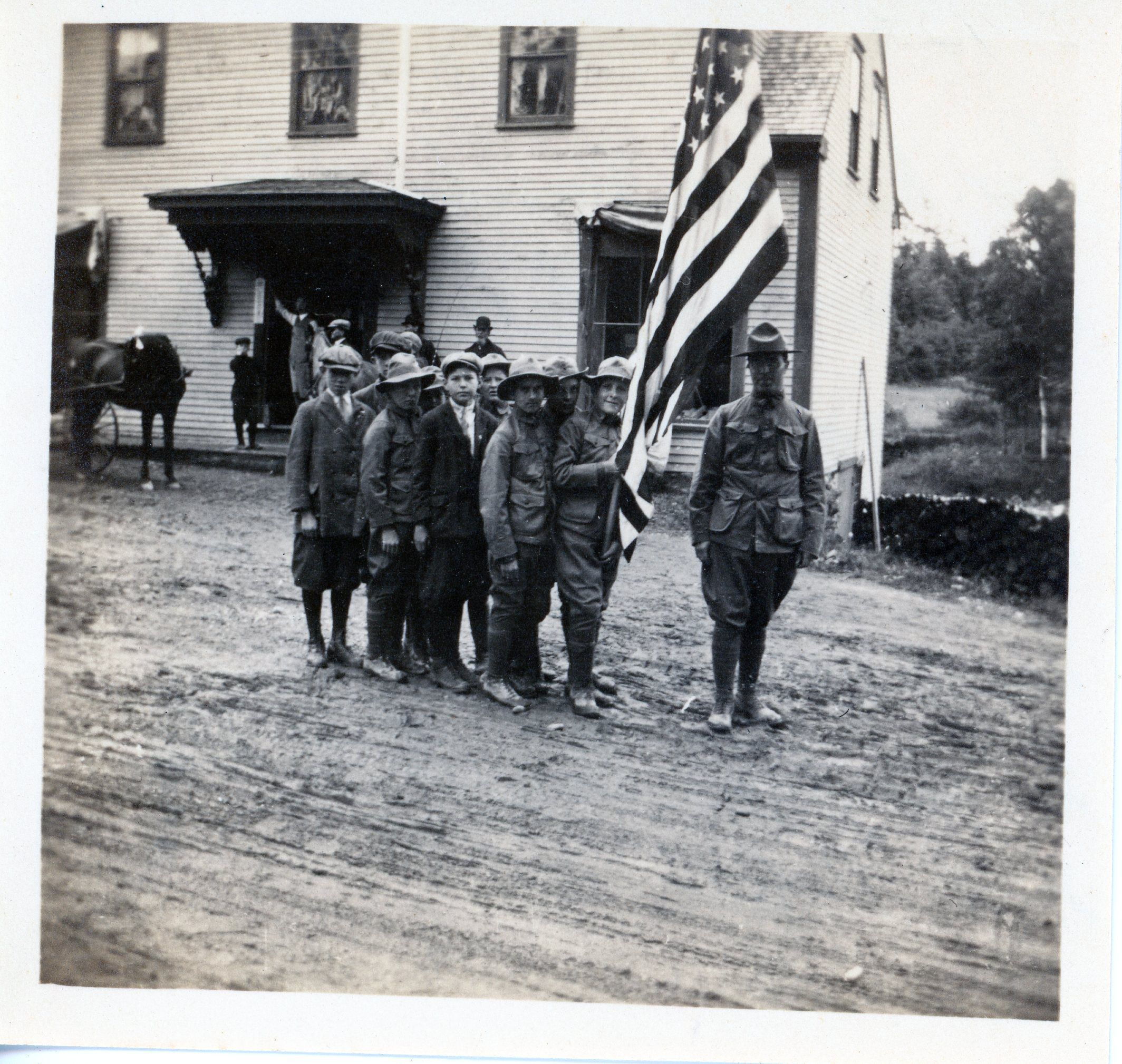 Dennysville's first Boy Scout troop, in front of A.L.R. Gardner's Store; The Reverend Roland Hankin stands with this first Boy Scout Troop formed in Dennysville, Maine, c. 1915. Mr. Hankin was the Pastor of the Dennysville Congregational Church until he moved to the West Coast of the United States around 1920.