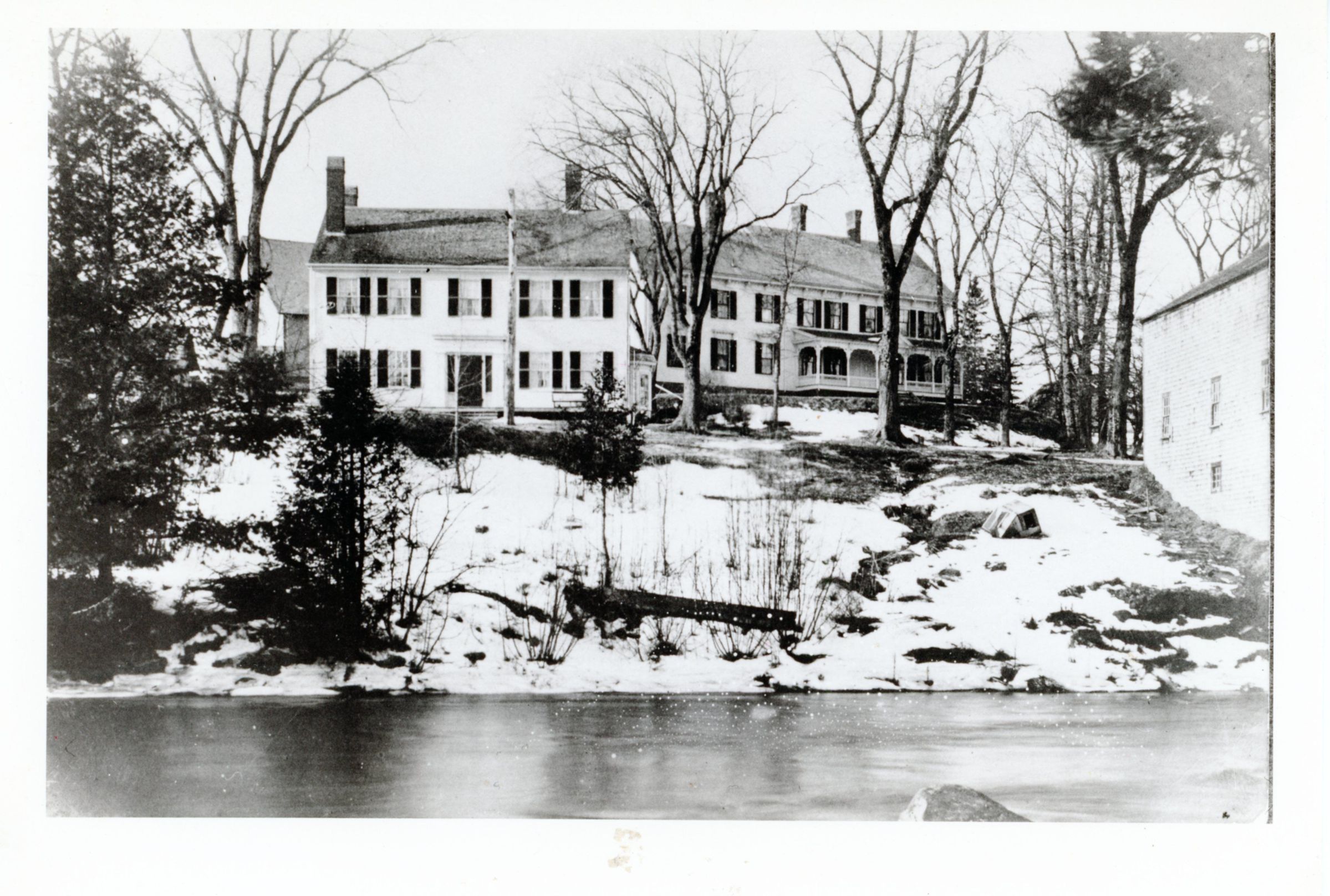 Riverside Inn and Dennys River Inn, Dennysville, Maine; The images shows the Riverside Inn on the left, with Dennys River Inn above and to the right, while John Allan's livery stable on the far right.