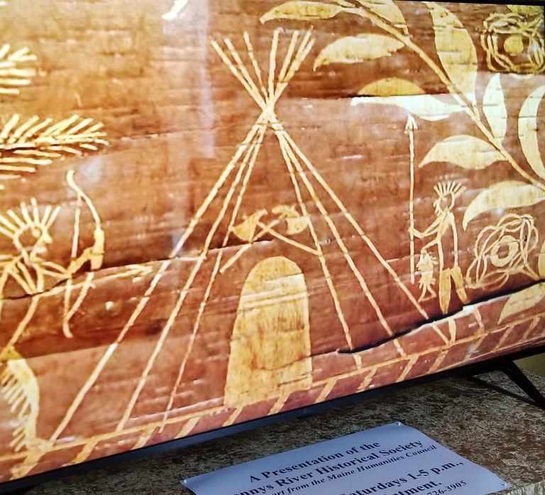          Forest Dwellers on Birchbark; A birchbark pictogram of ancestral Passamaquoddy forest dwellers at home among the plants and other natural resources they harvested for food and medicine.  Artwork by Tomah Joseph, reproduced from the film 