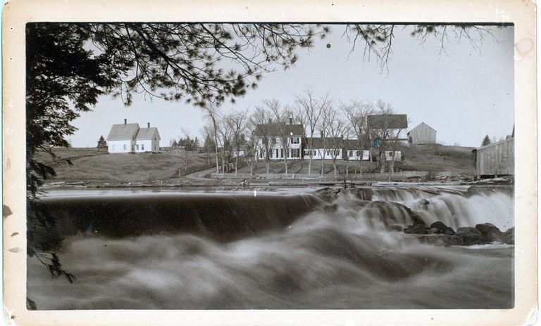          The Lincoln Dam and T.W. Allan houses in Dennysville, as seen from the Edmund side of the Dennys River.; Photograph by John P. Sheahan, c. 1885.
   