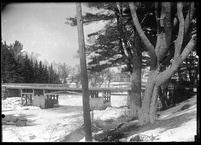          Lower Bridge over the Dennys River in winter.; View of the Lower Bridge over the icebound Dennys River as seen from Edmunds, looking towards the Lincoln House in Dennysville.  Photograph by John P. Sheahan in the 1880's.
   