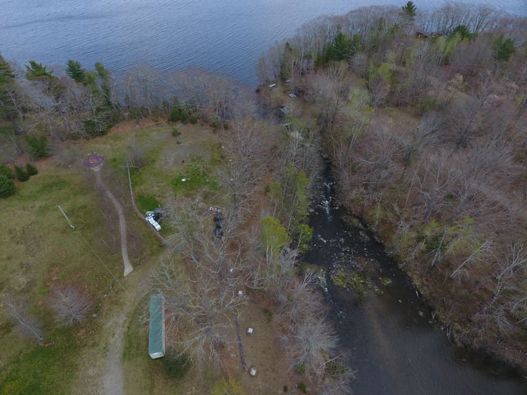          Eastern Surplus Superfund Site on the Dennys River in Meddybemps.; Test wells and other equipment line the bank of the Dennys River at its source on Meddybemps Lake as part of the continued monitoring of ground water contamination by the Environmental Protection Agency.  The land itself was the location of an ancestral Wabanaki Village established 9000 years ago, and occupied until the time of the American Revolution.  In 2021 it was returned to the Passamaquoddy Tribe by the State of Maine.  Photograph courtesy of Jeffrey Orchard.
   