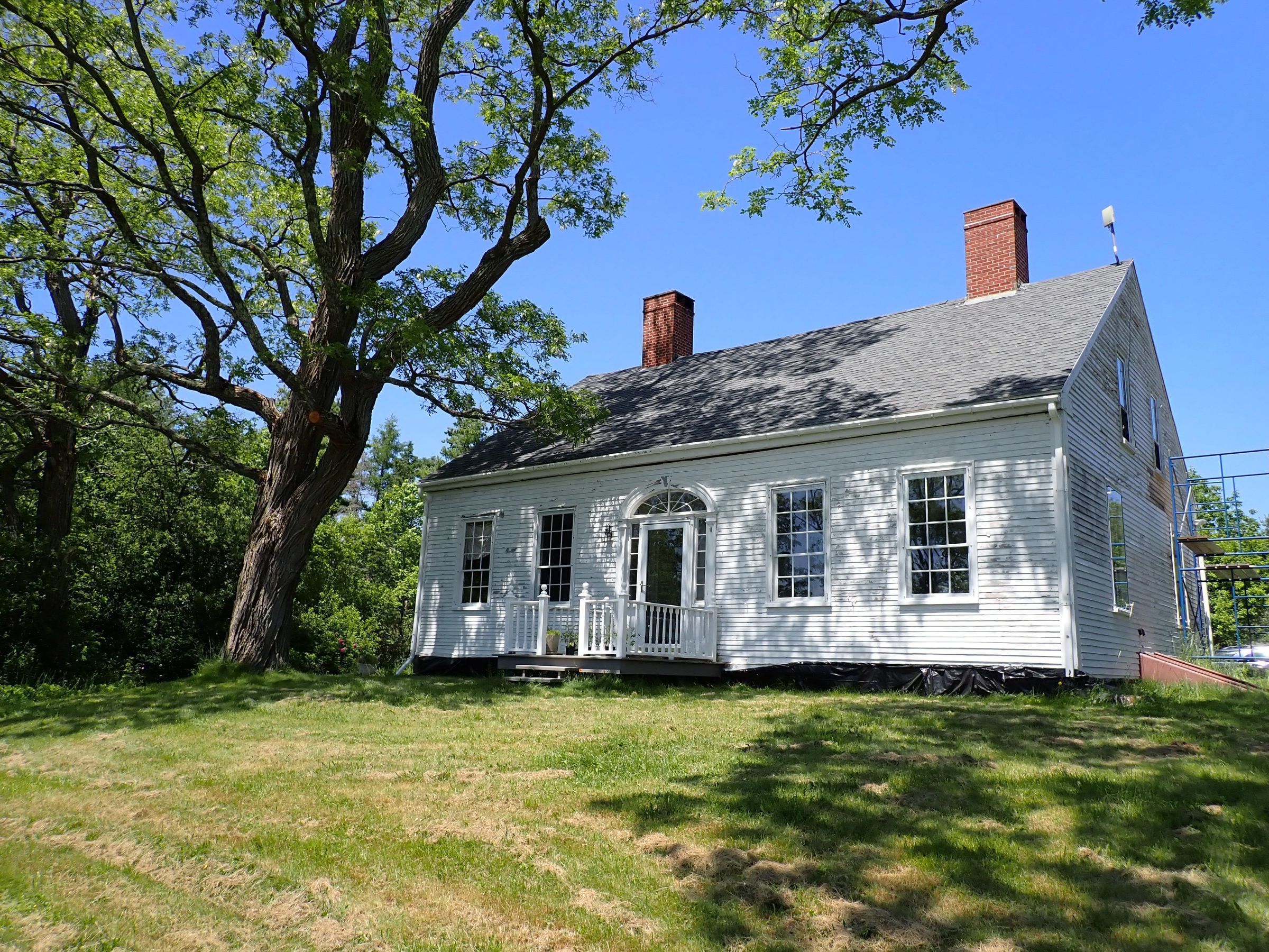 Bela R. Reynolds House on the Narrows Road, now Foster Lane; Cape style house built by Bela R. Reynolds for himself and his wife Deborah (Wilder), daughter of E.C. Wilder, Sr., in the 1820's. Bela Reynolds operated a packet service to Eastport from a wharf at the foot of the hill where his house in located, where he drowned, a short distance from shore, on May 3rd, 1853.