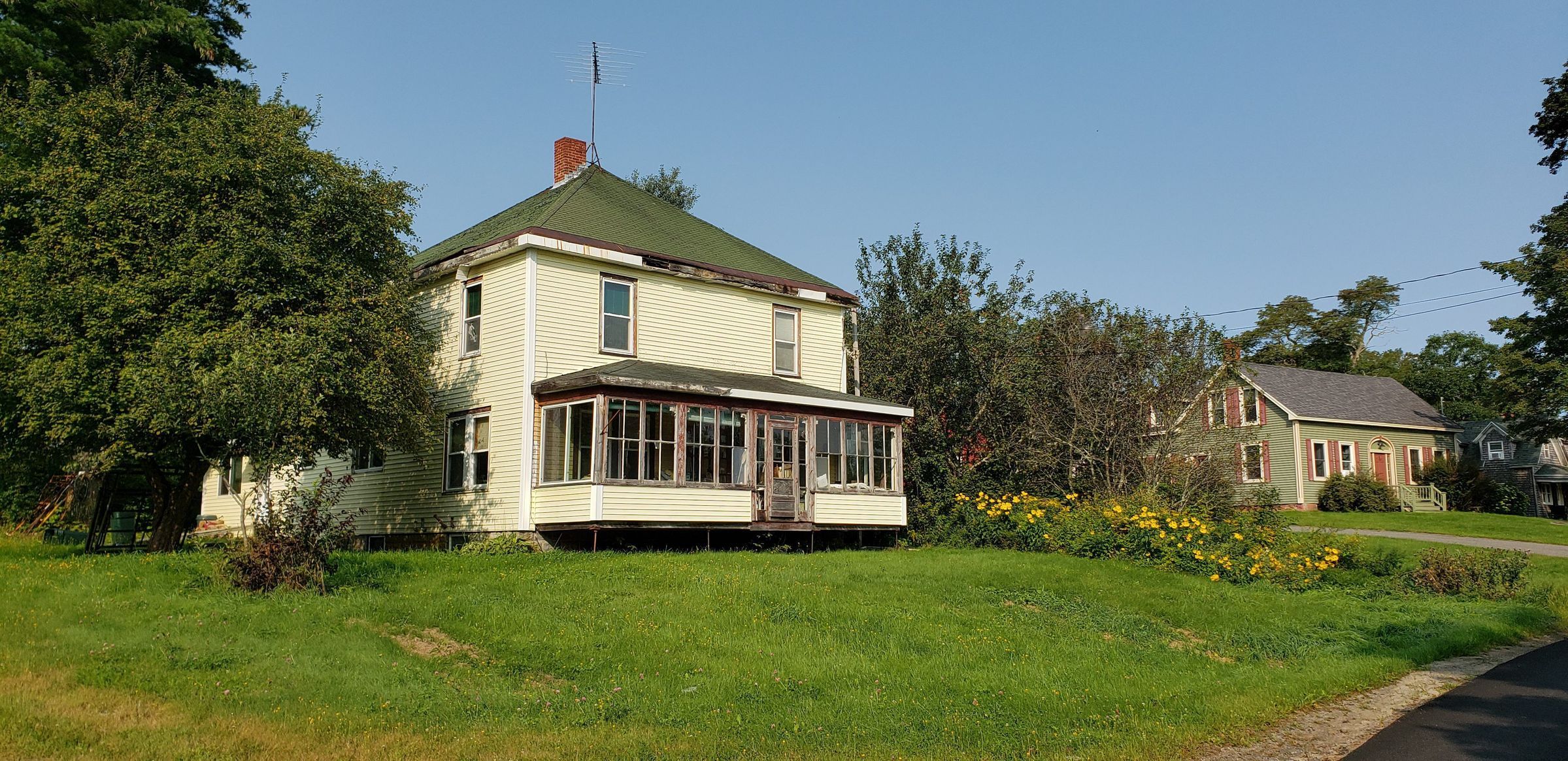 The Hodgdon House on the Lane, Dennysville Maine, 2023; The former mill house built by S.D. Warren Company workers in the 1920's, later owned by Ken Hodgdon, catches the morning sun in 2023, along with Solomon Foster house next door.