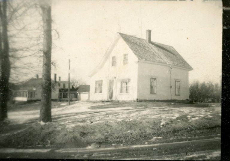          Howard Allan's House in Meddybemps, Maine, c. 1960; Howard Allan's house in Meddybemps village around 1960, which was located almost directly in front the Town Hall,  with the Ward house visible beyond it.
   