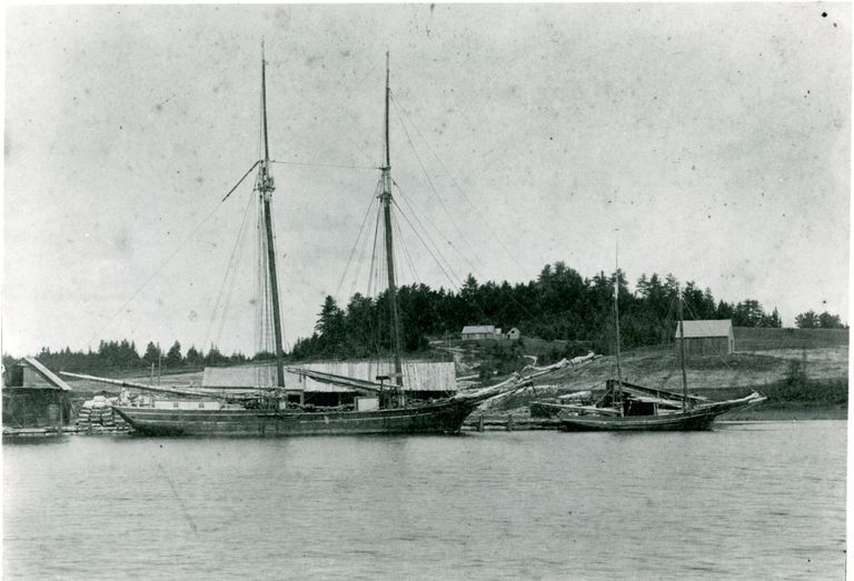          Schooner and packet at the Lincoln Wharf on the Dennys River, with Corn Hill in view.; Edmunds Lincoln's modest house and a barn are visible on Corn hill, behind the schooner and packet tied up at Lincoln's Wharf on the Dennys River in Dennysville, Maine, c. 1890.
   