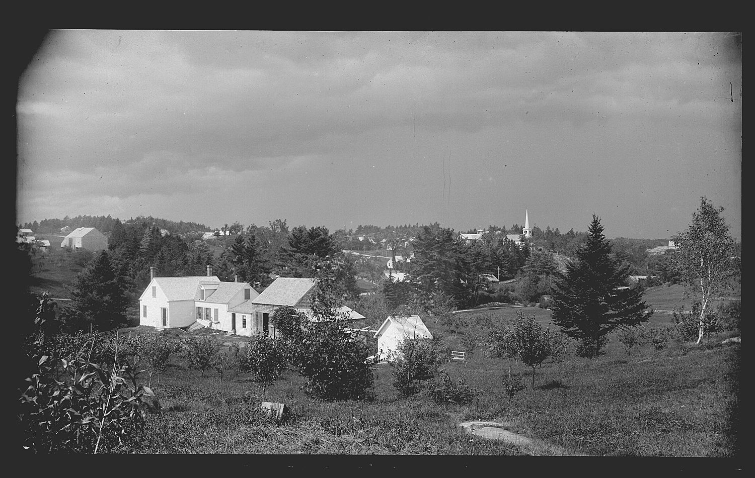 John P. Sheahan House in Edmunds, Maine, c. 1890; View of Dr. John Parris Sheahan's house in Edmunds with Dennysville village in the background, in a photograph by John Parris Sheahan.