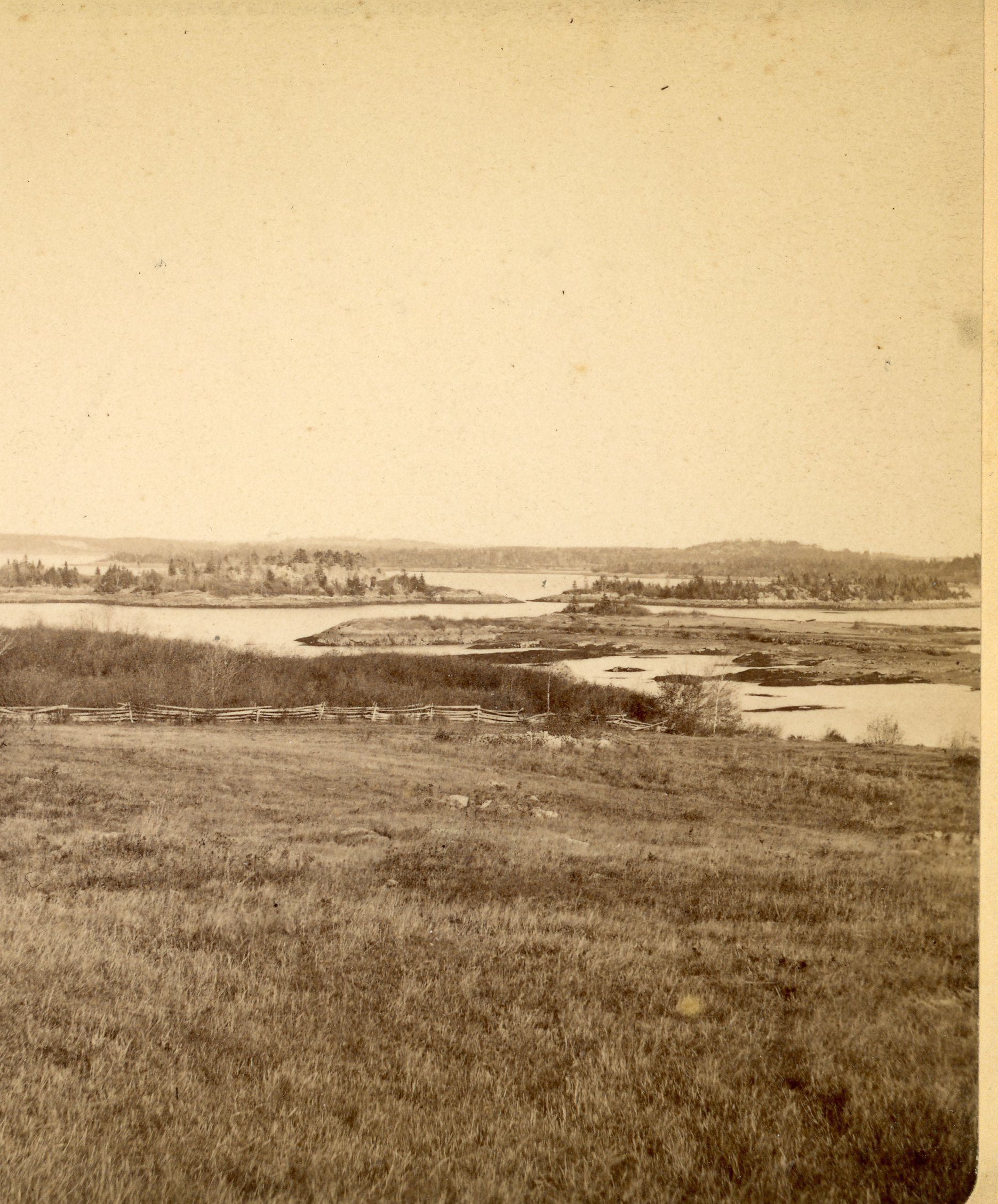 Birch Islands, Edmunds, Maine; This view was taken from the Capt. Ralph Hallowell farm, South Edmunds, Road, Edmunds, Maine. The foreground is the saltwater farm field with an island between the field and the Birch Islands. Behind the lefthand island is Dram Island and the Pembroke shore. Between the islands and moving right is the Trescott shore in the background. Photo courtesy of The Tides Institute, Eastport, Maine