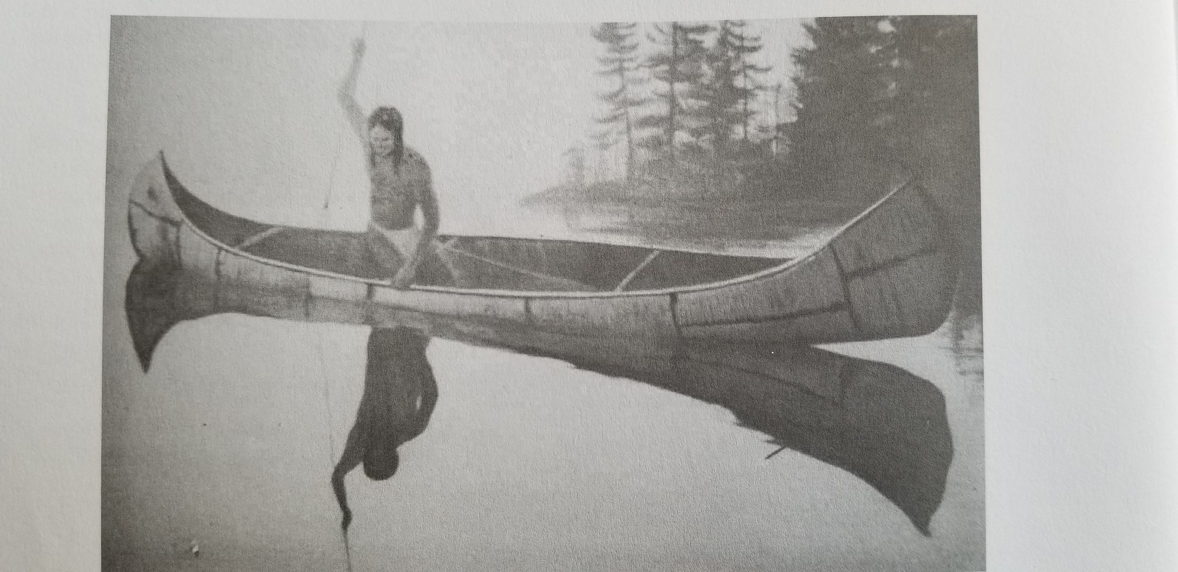 A lone Wabanaki fisherman poised to spear a fish from his birchbark canoe.; Reproduced with permission from