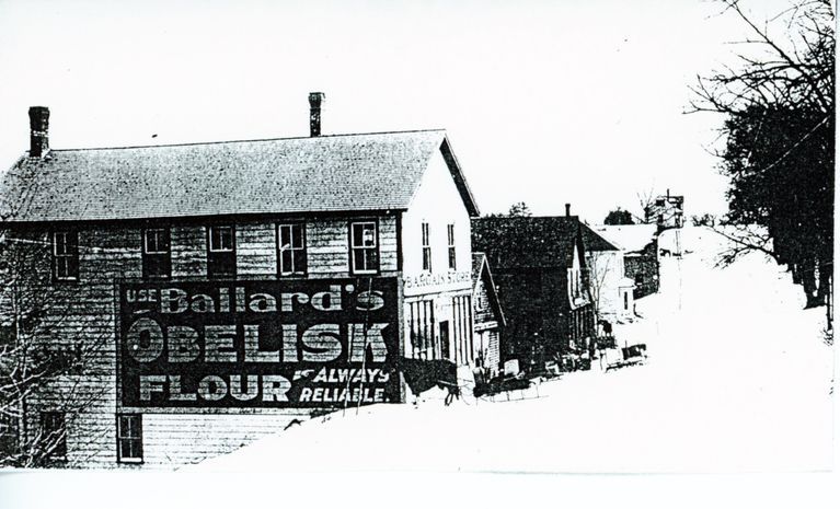          Walter Dodge's Store, Dennysville, Maine; Beyond the store building, can be seen the front of George Brown's blacksmith shop, Kilby's Store, John Allan's livery stable up to Vose's store on the crest of Store Hill.
   