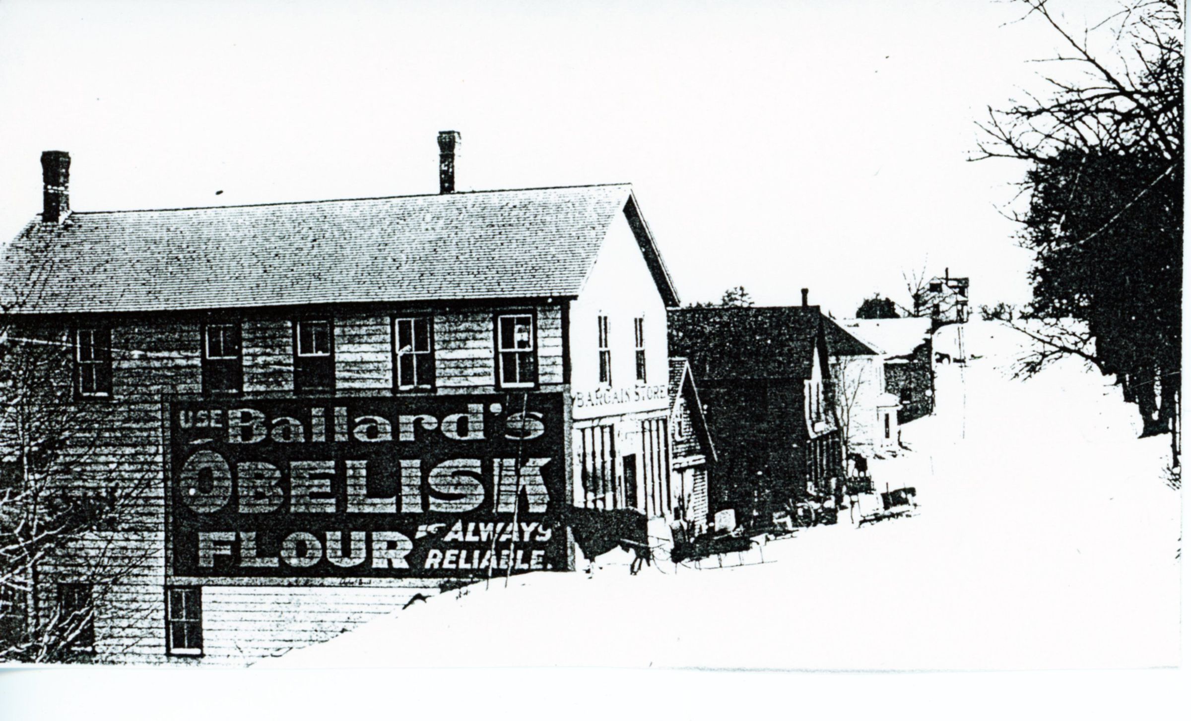 Walter Dodge's Store, Dennysville, Maine; Beyond the store building, can be seen the front of George Brown's blacksmith shop, Kilby's Store, John Allan's livery stable up to Vose's store on the crest of Store Hill.
