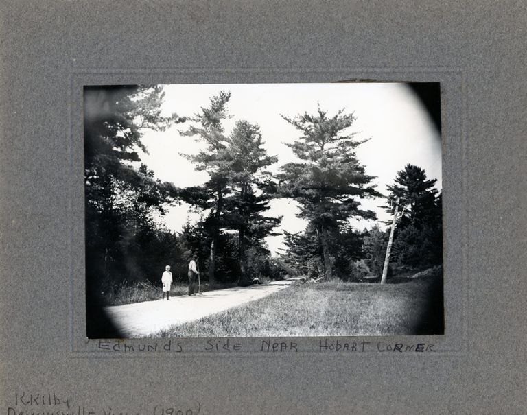          River Road Near Hobart Corner, Edmunds, Maine; A view of the River Road in front of the house of John P. Sheahan, in Edmunds, Maine.  A child is standing near several men working on the road. Photo courtesy of The Tides Institute, Eastport, Maine, with a caption by Keith Kilby.
   