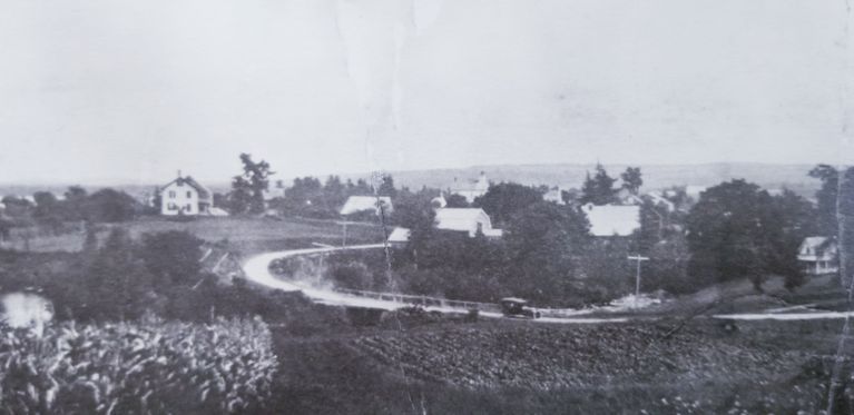          Panorama of Meddybemps Village, c. 1930; Detail of a panoramic view of the village of Meddybemps c. 1930.  Note the old touring car in the center of the picture.  The Harrison House is seen on the hill to the left.
   