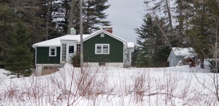          Green House on Rte. 86, Marion, Maine near Katie Maker's Corner.; A snug green house of modern design rests under a blanket of snow on a cold winter's day in Marion.
   