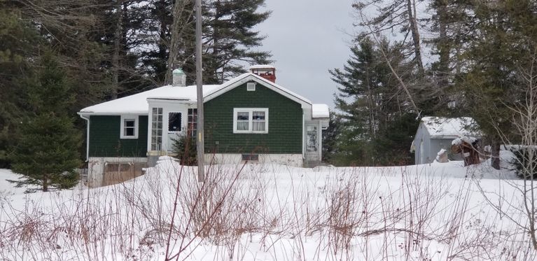          Green House on Rte. 86, Marion, Maine near Katie Maker's Corner.; A snug green house of modern design rests under a blanket of snow on a cold winter's day in Marion.
   