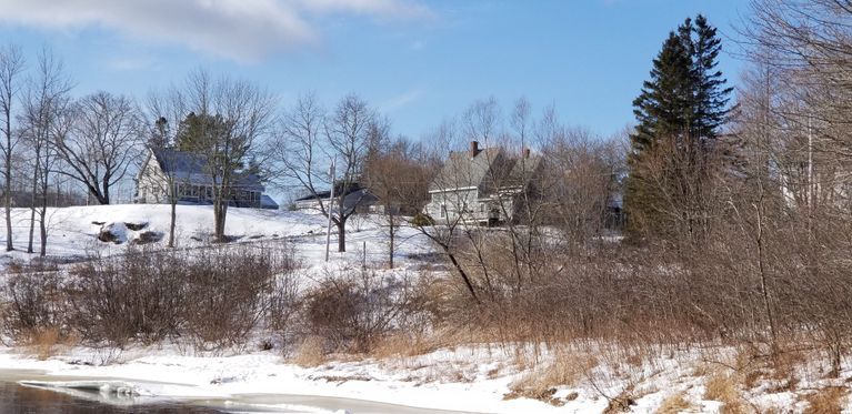          The Peter and Abner Gardner Homes, Dennysville, Maine; The  Peter (left) and Abner (right) Gardner Houses, Cemetery Road. Dennysville, Maine. This view is looking uphill from the mill pond and dam site.
   