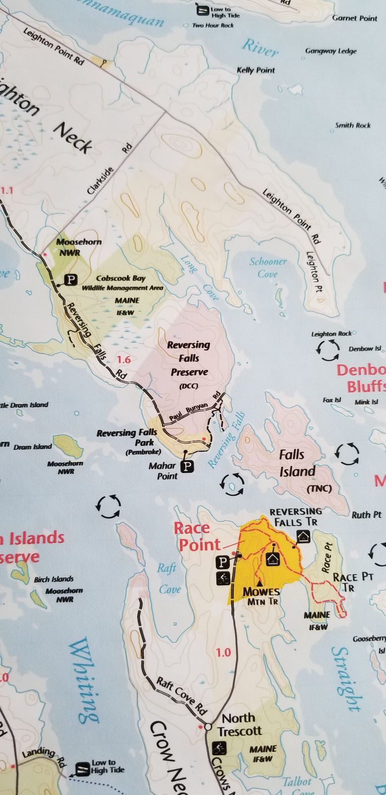          Conservation Land on the tip of Leighton's Neck in Pembroke, Maine, in 2022; A checkerboard of land under conservation management around the Reversing Falls on Leighton's Point Pembroke and Crow Neck, Trescott, Maine.  These include the Moosehorn National Wildlife Refuge (NWR), Maine Department of Inland Fisheries and Wildlife (IF&W), Downeast Coastal Conservancy (DCC), The Nature Conservancy (TNC), Cobscook Shores Foundation, and the Town of Pembroke. This detail is from a larger trail map of the area prepared by the Cobscook Shores Foundation in 2022.
   