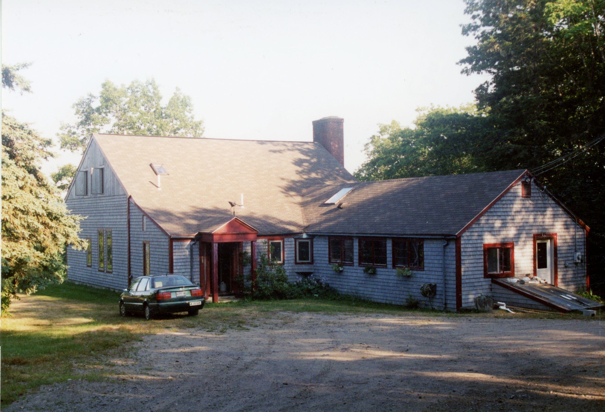 View shows entrance at left and kitchen wing at right side of building.