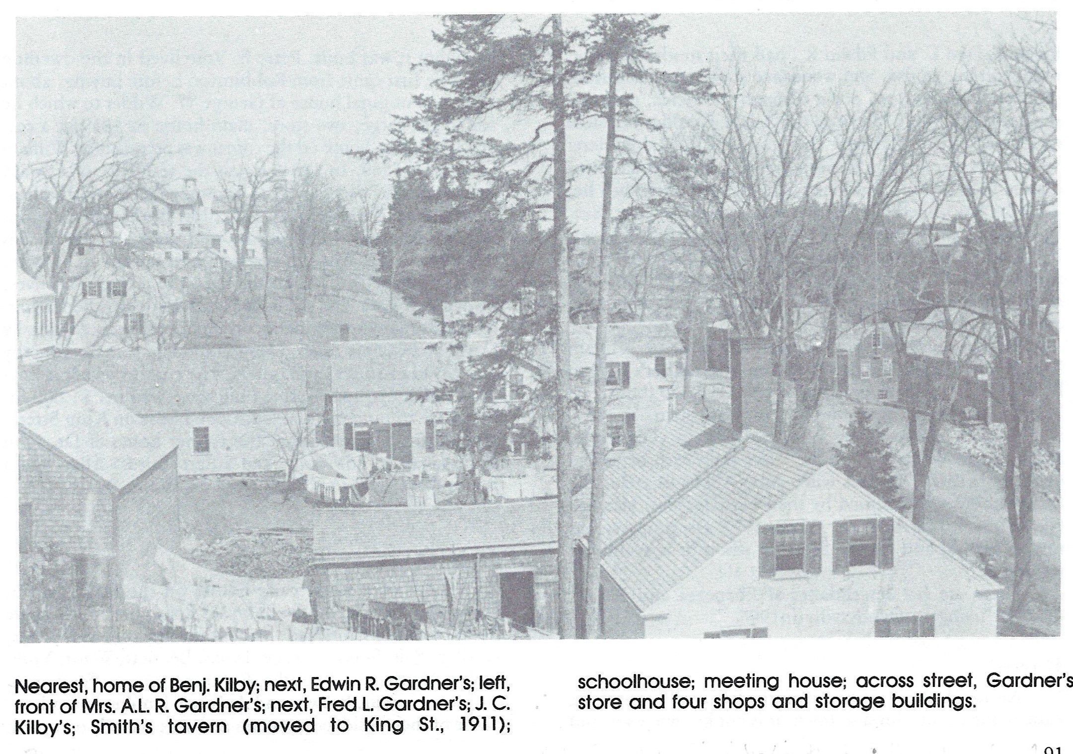 Houses and Stores on Water (now Main) Street, Dennysville Me, 1910; Looking over the rooves of Benjamín Kilby's and Edwin Gardner's houses, the front of Mrs. A.L.R. Gardner's and Fred Gardner's are in view, facing Gardner's stores on the opposite side of the road.
Uphill are William Kilby Jr.'s house and the former John Smith tavern, with the school and steeple of the Congregational meetinghouse beyond. Image is from the archives of the Dennys River Historical Society, as reproduced in Rebecca W. Hobart's town history,